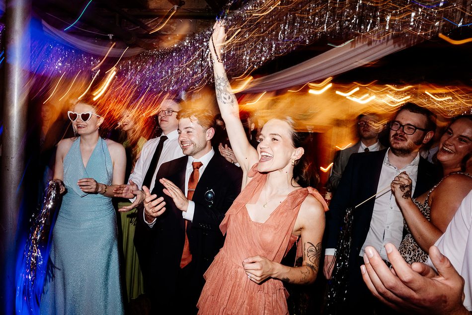 Wedding guests dancing and celebrating at a party with saxophone