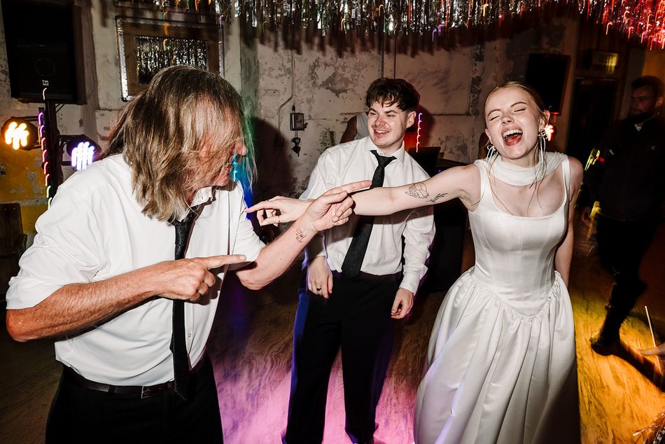 Bride laughing and dancing with guests during Paul Martyn's wedding party set