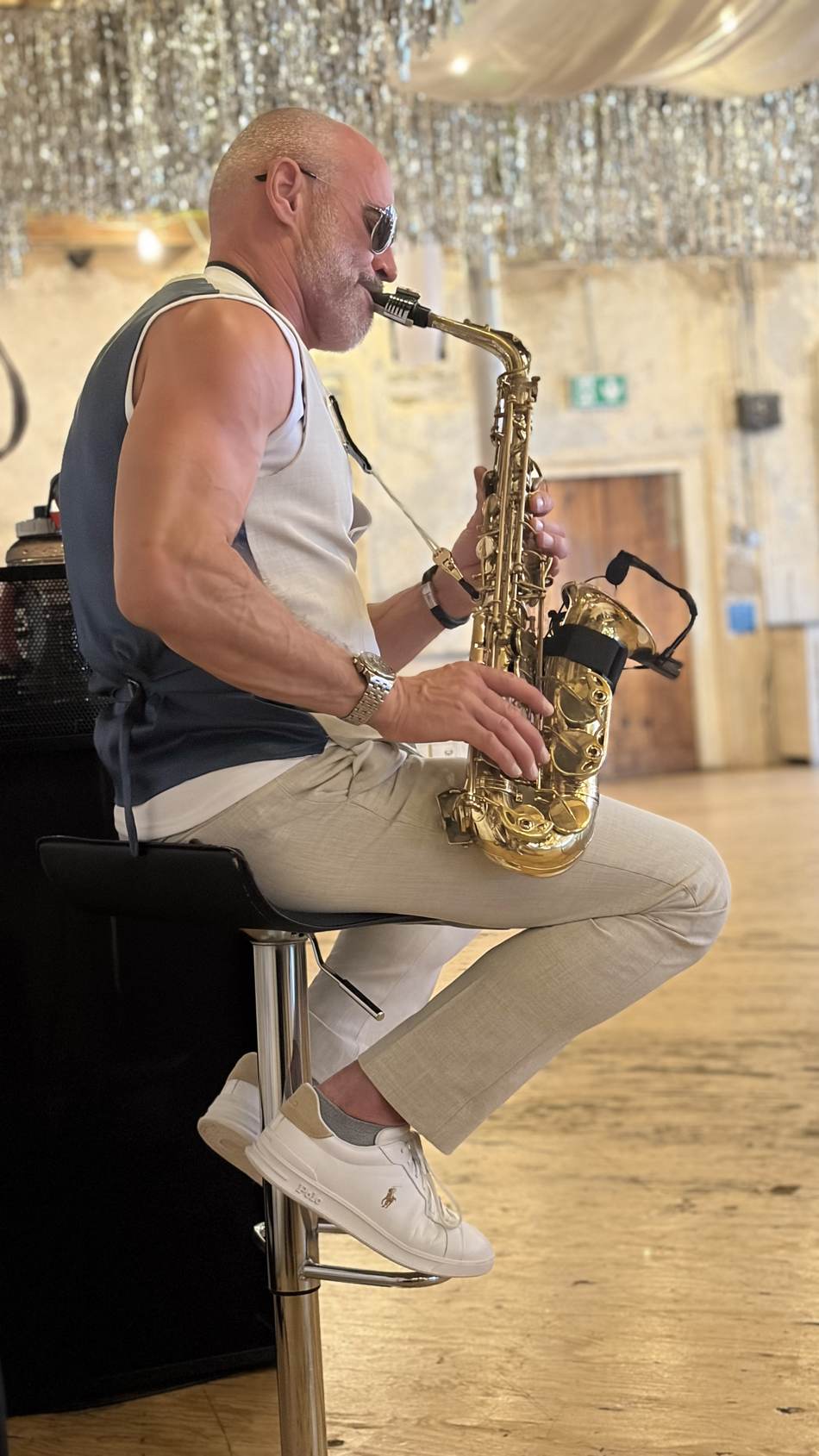 Paul Martyn seated playing saxophone